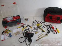 Overall view of all tools, tool case and bag on table