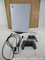 Front view of PS5 console with controllers, cords, stand