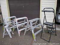All five ladders standing outside garage