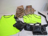 Overall lot view: six neon shirts, three tool belts