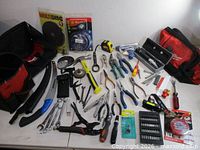 Overview of all hand tools, drill bits, saw, bags and accessories laid out