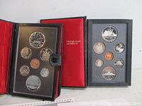Two open RCM presentation cases showing coins in holders