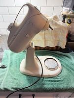 Left side profile of KitchenAid Model K3C stand mixer base showing body, cord and missing bowl platform