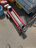Top view of red and black electric log splitter showing steel beam and power cord