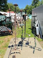 Group of wrought iron candle stands on outdoor table