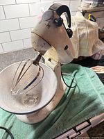 Mixer with bowl and whip on countertop showing overall condition