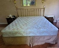 Full view of brass king bed with mattress and box spring