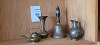 Group shot showing all four brass items together