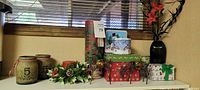 Overall lot showing jars, tins, boxes, reindeer, candle, vase with poinsettias