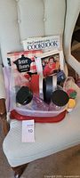 Cookbooks, plastic containers, jars and accessories displayed on chair