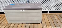 Front view of closed deck box on wooden deck