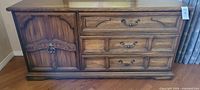 Front view of oak dresser showing drawers, cupboard doors and hardware