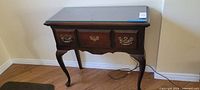 Front view of entrance table showing drawers, legs and overall form