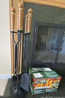 Full view of fireplace tool set on stand beside Enviro-Log box