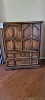 Front view of oak hutch dresser with doors closed and two lower drawers visible