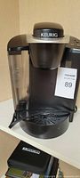 Front view of Keurig coffee maker showing overall design and drip tray