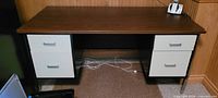 Front view of desk with four drawers and frame