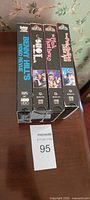 Spines of four VHS tapes lined side-by-side