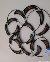 Full view of interlocking circular metal wall art on wall