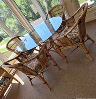 Full view of rattan table and four chairs in sunroom