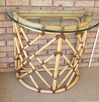 Front view of rattan half-moon table with glass top