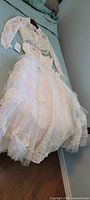 Dress and bolero laid out on bed