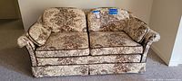 Front view of floral upholstered loveseat
