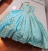Full view of dress laid flat showing overall design and belt