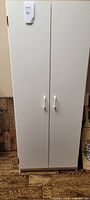 Front view of cabinet with double doors and handles