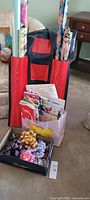 Overall view showing wrapping paper rolls in organizer, gift bags and box of bows