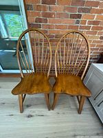 Front view of both wooden hoop back chairs