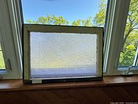 Front view of complete glass panel in frame