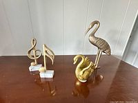 Group view of heron, swan, treble clef and eighth note figurines on tabletop