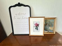 Three framed wall art pieces on tabletop