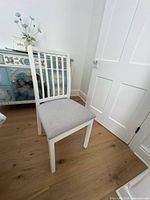 Full view of IKEA chair, white frame, grey seat