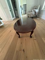Top view of oval cherry coffee table showing surface and legs