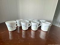 Eight Corning Ware Shadow Iris mugs grouped