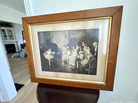 Front view of framed black-and-white print on stand