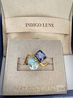 Ring in display box showing stones and twisted band