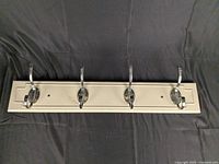 Front view showing entire rail with four hooks