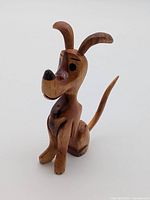 Front left view of wooden dog figurine