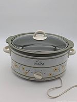 Front view of Rival Crock-Pot showing floral design, dial, glass lid and power cord