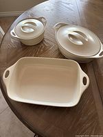 Top view of three stoneware pieces showing shapes and lids