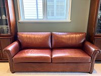 Front view of brown leather sofa