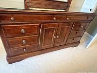 Front view of dresser showing cherry finish, drawers, cabinet, and hardware