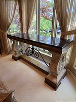 Full view of console table by window showing overall design and scale