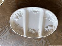 Top view showing three compartments and embossed fruit design