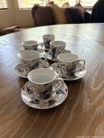 all six espresso cups with their saucers displayed on table