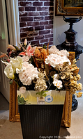 Box filled with assorted artificial flower stems in various colors and types