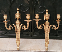 Pair of gilt brass 3-arm wall sconces front view showing all decorative details